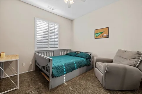 a bedroom with a bed and a couch