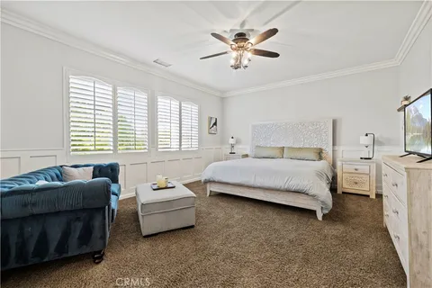 a bedroom with a bed a couch and window