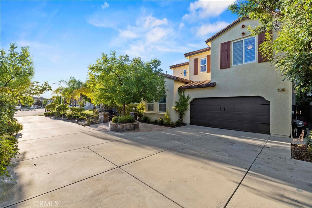 24303 Las Palmas Street Valencia, CA 91355 - Photo 2 of 34 a front view of a house with garden