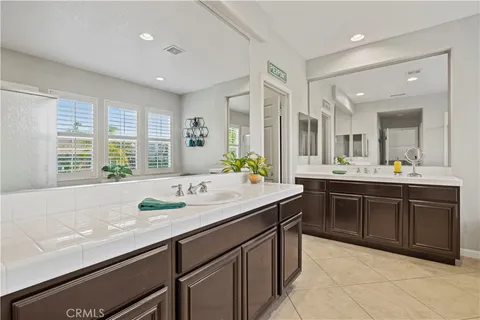 a bathroom with a sink double vanity and a mirror