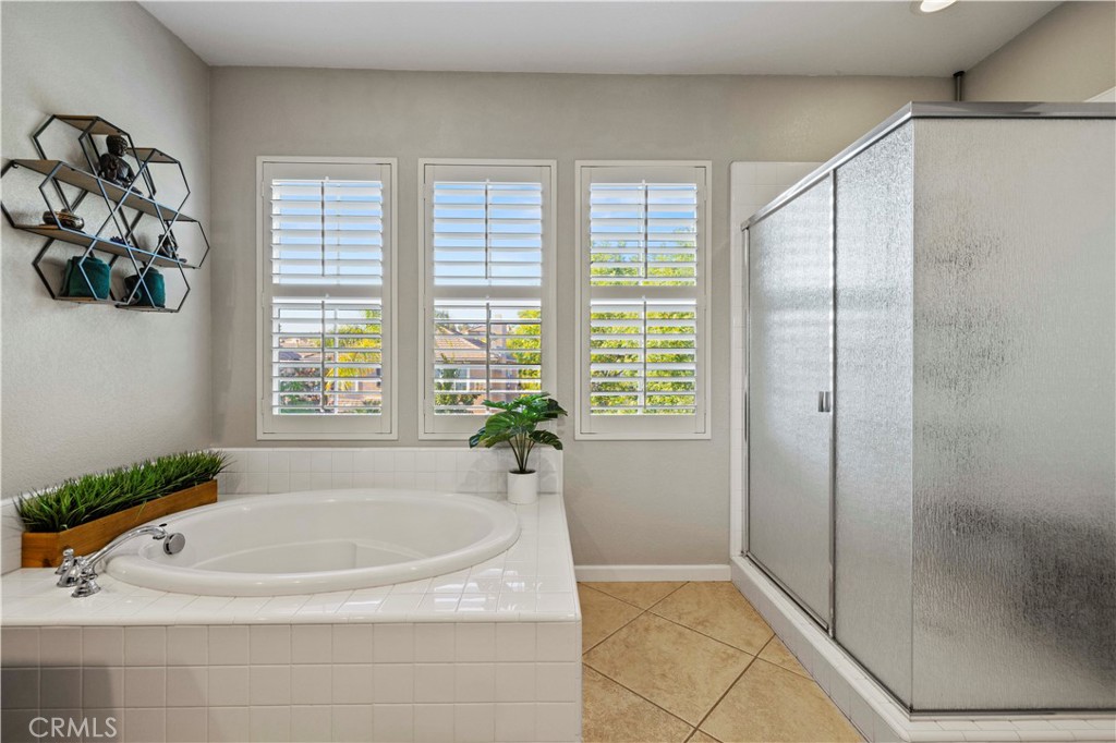 24303 Las Palmas Street Valencia, CA 91355 - Photo 23 of 34 a bathroom with a tub and a shower
