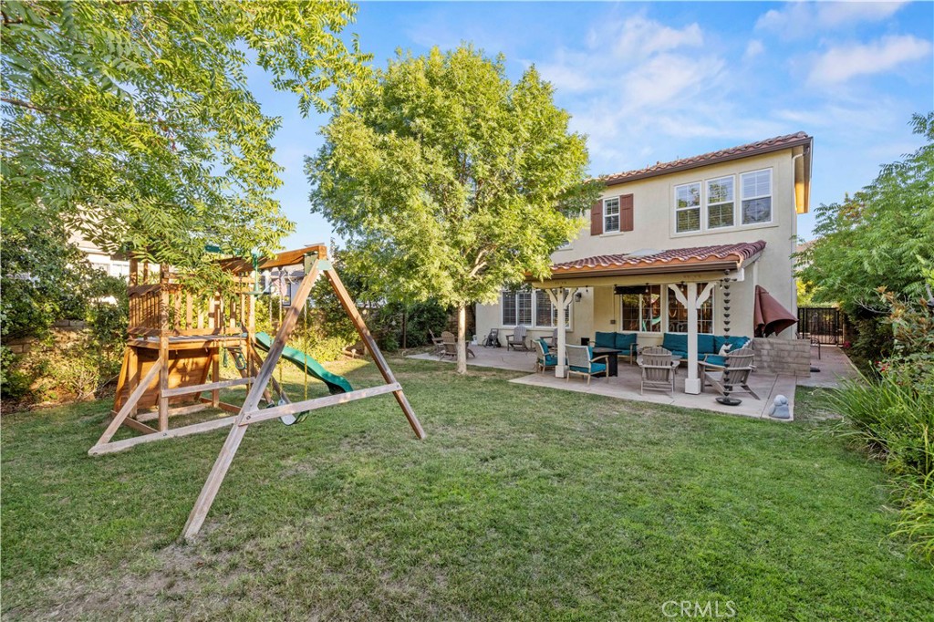 24303 Las Palmas Street Valencia, CA 91355 - Photo 24 of 34 a view of a house with a yard patio and slide