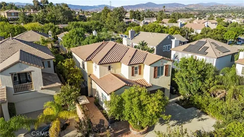 an aerial view of a house with a yard