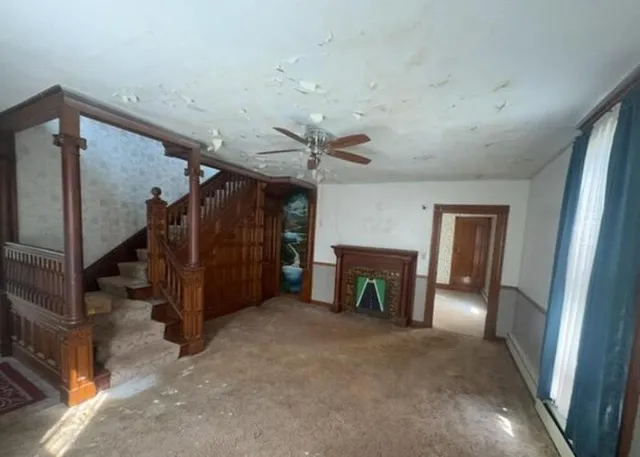 a view of an empty room with a fireplace