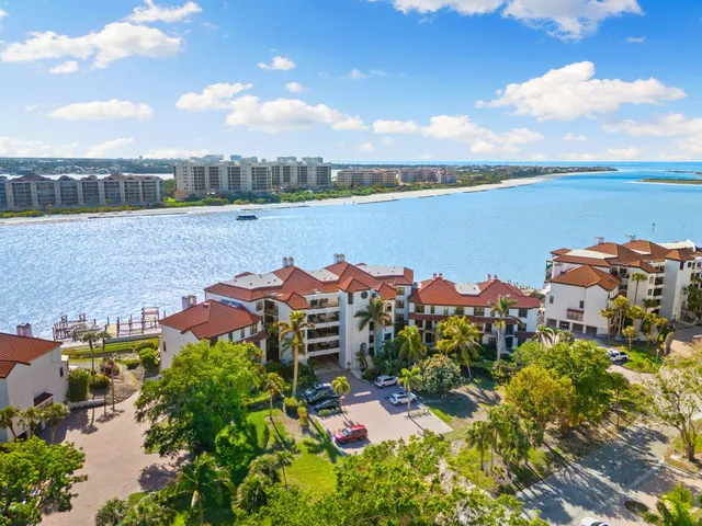an aerial view of a house with a garden and lake view