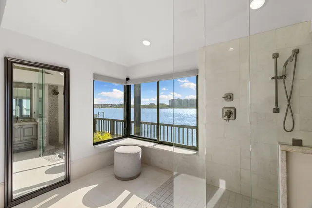 a bathroom with a shower a sink and a mirror