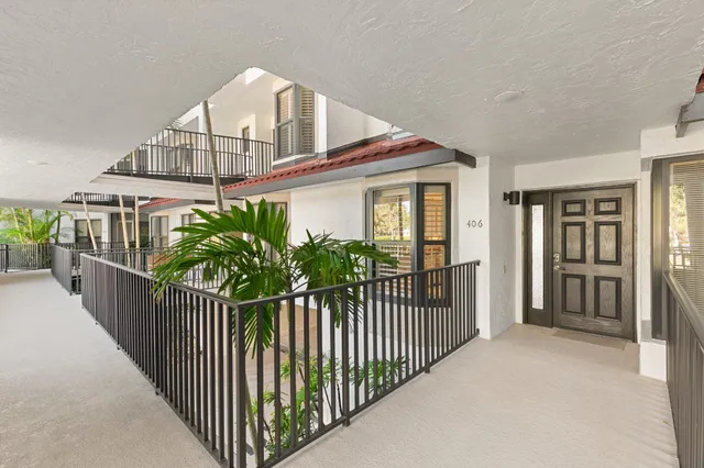 a view of a house with wooden fence