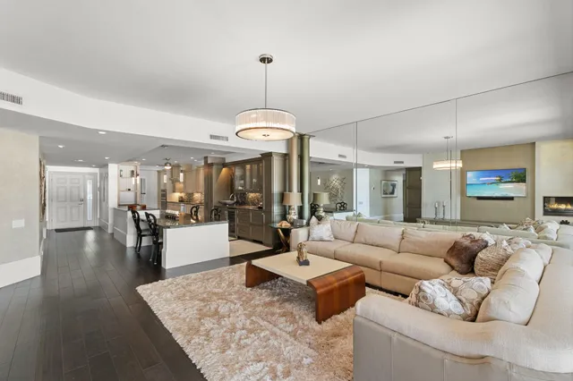 a living room with furniture and a chandelier