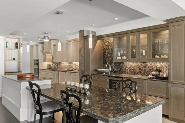 a dining room with furniture and large windows