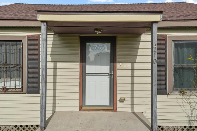 a view of front door and a car parked