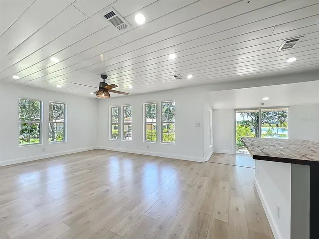 a kitchen with stainless steel appliances kitchen island granite countertop a refrigerator and a sink