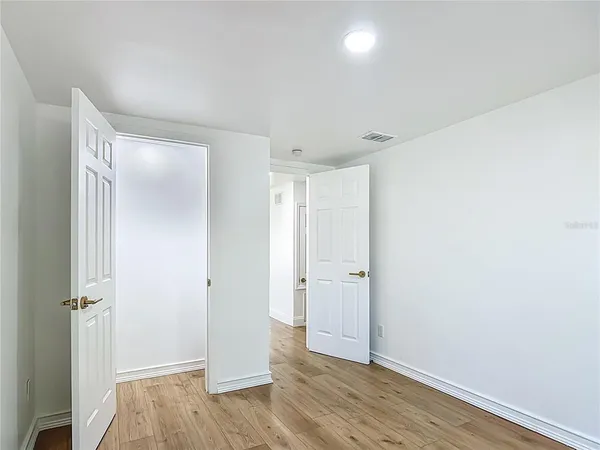 a kitchen with a sink cabinets and wooden floor