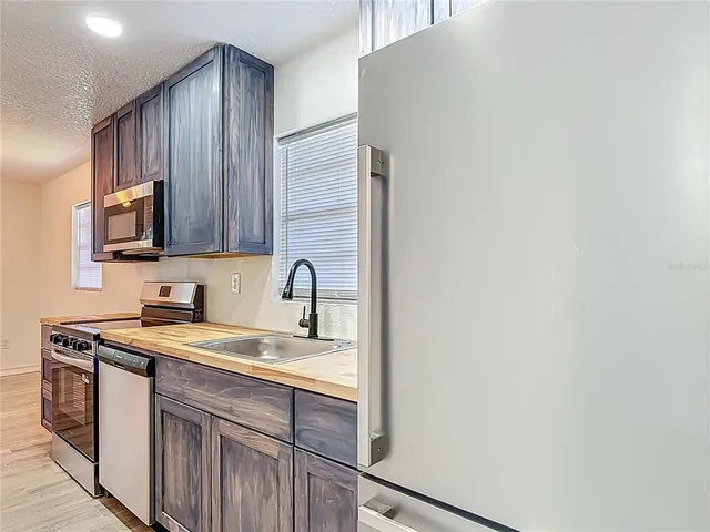 a view of house with backyard and garden