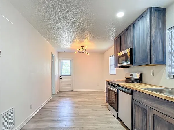 a backyard of a house with table and chairs
