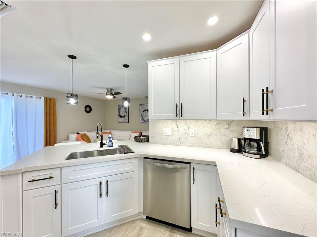 3639 Kent Drive Naples, FL 34112 - Photo 17 of 39 a kitchen with a sink dishwasher and white cabinets