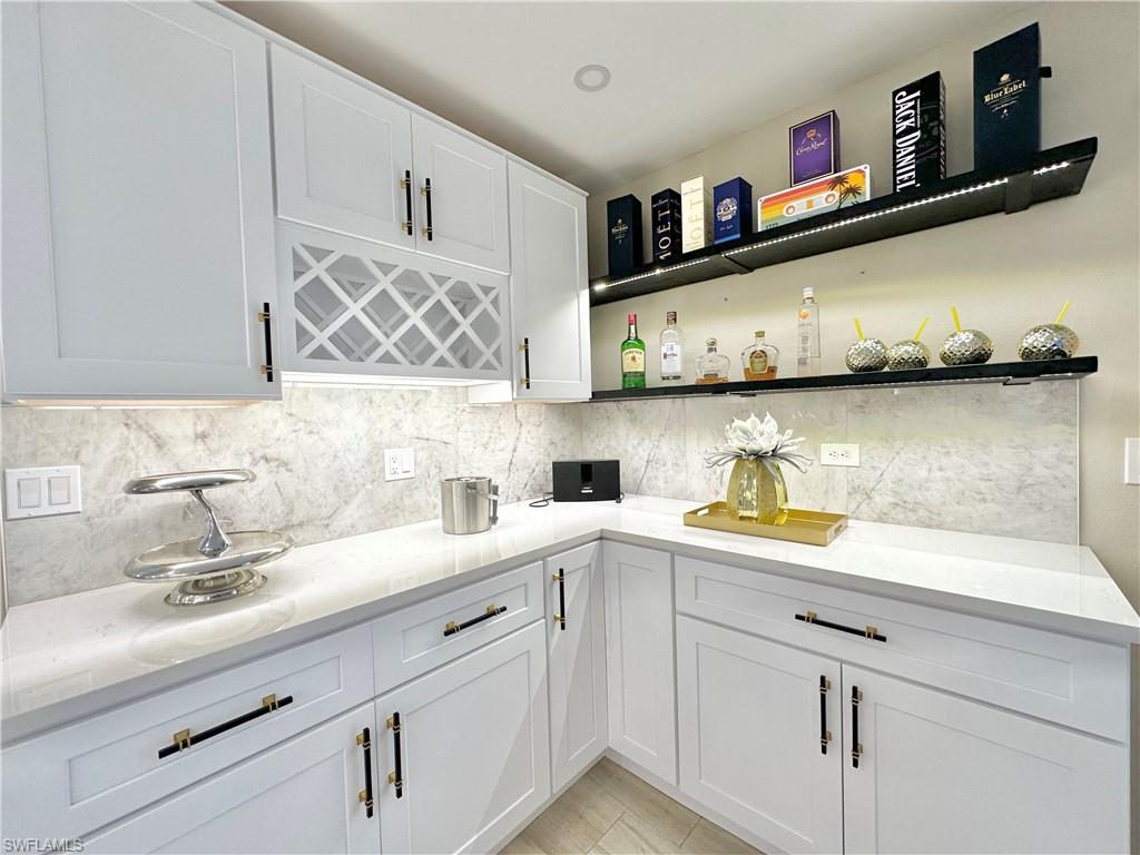 3639 Kent Drive Naples, FL 34112 - Photo 19 of 47 a kitchen with stainless steel appliances granite countertop a sink a stove and cabinets