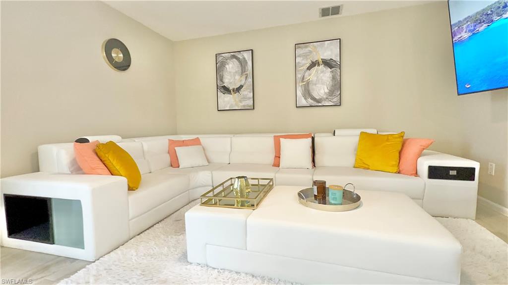 3639 Kent Drive Naples, FL 34112 - Photo 20 of 47 a bedroom with a bed and couch