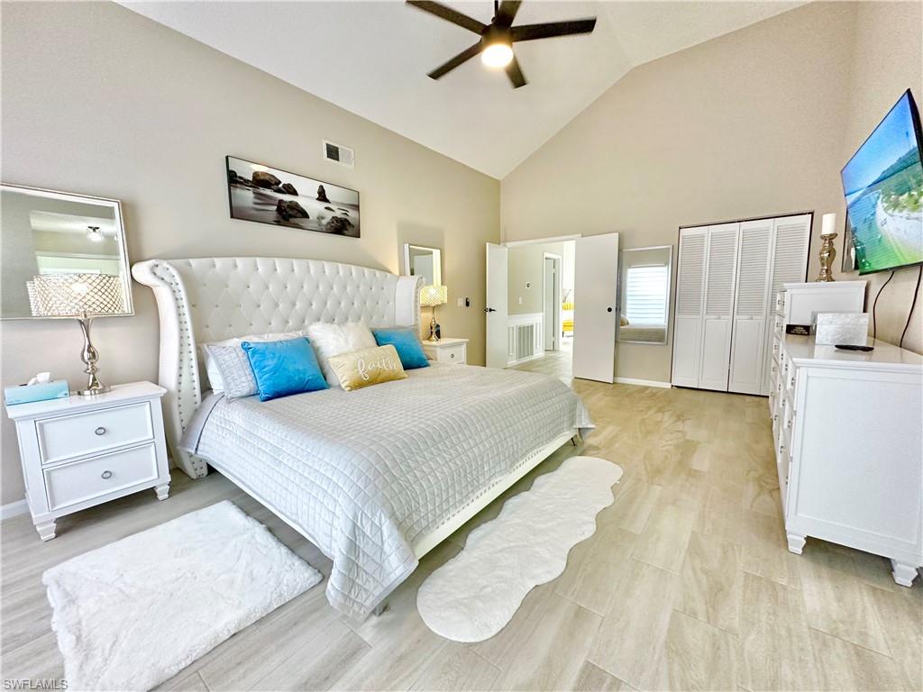3639 Kent Drive Naples, FL 34112 - Photo 23 of 47 a spacious bedroom with a bed and cabinet
