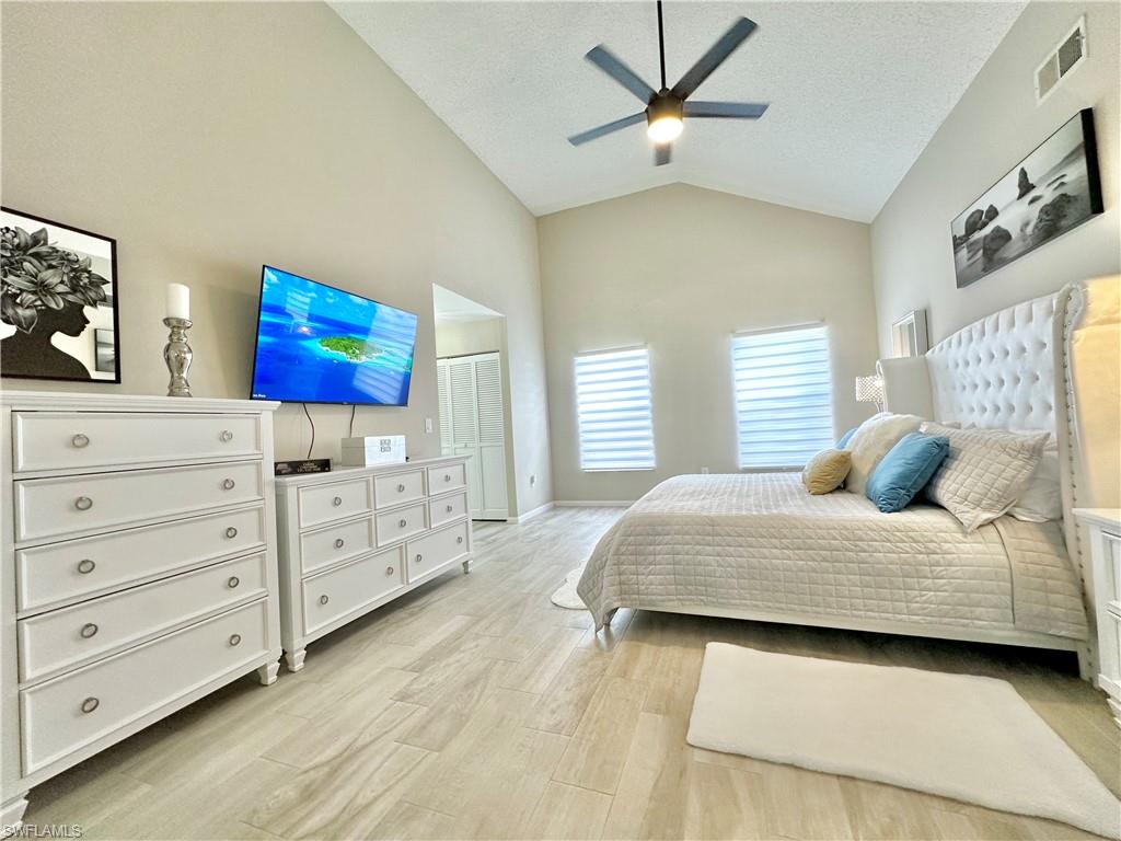 3639 Kent Drive Naples, FL 34112 - Photo 23 of 39 a bedroom with a bed and a dresser