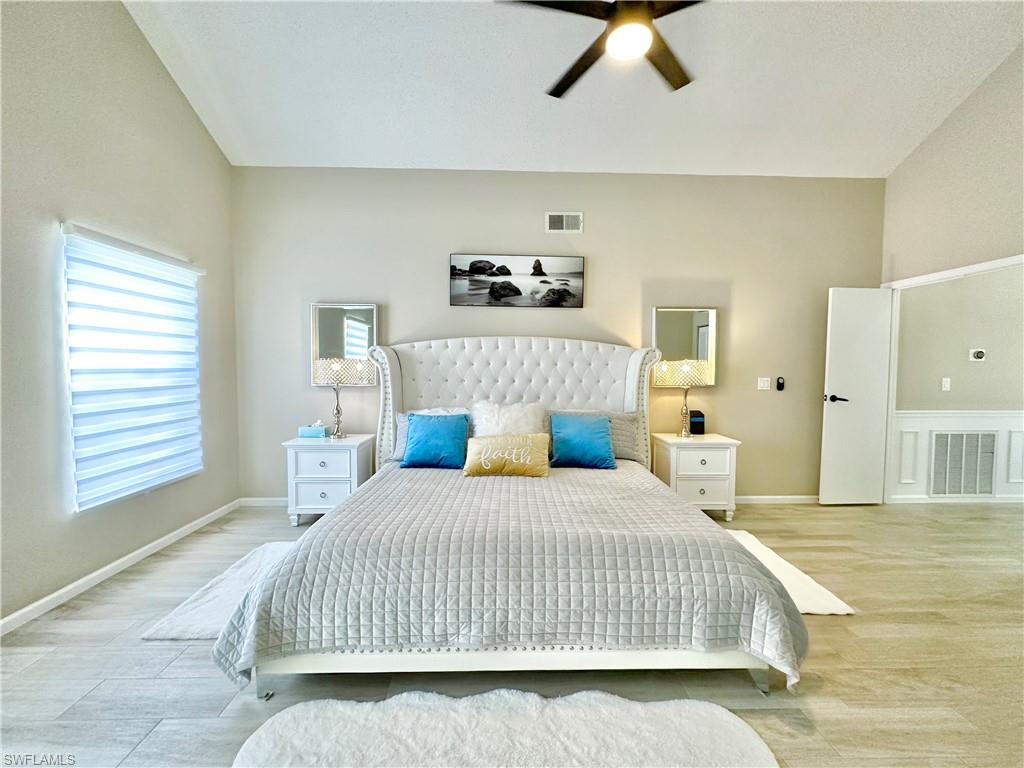 3639 Kent Drive Naples, FL 34112 - Photo 27 of 47 a bedroom with a bed and wooden floor