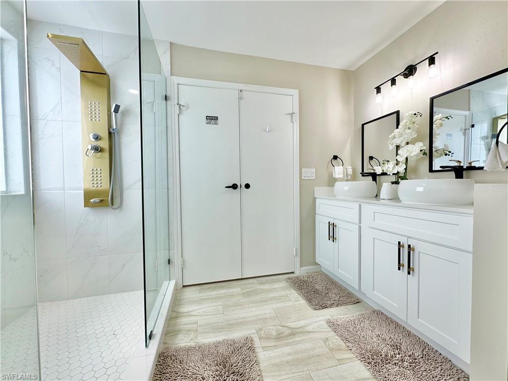 3639 Kent Drive Naples, FL 34112 - Photo 30 of 39 a bathroom with a sink and a mirror