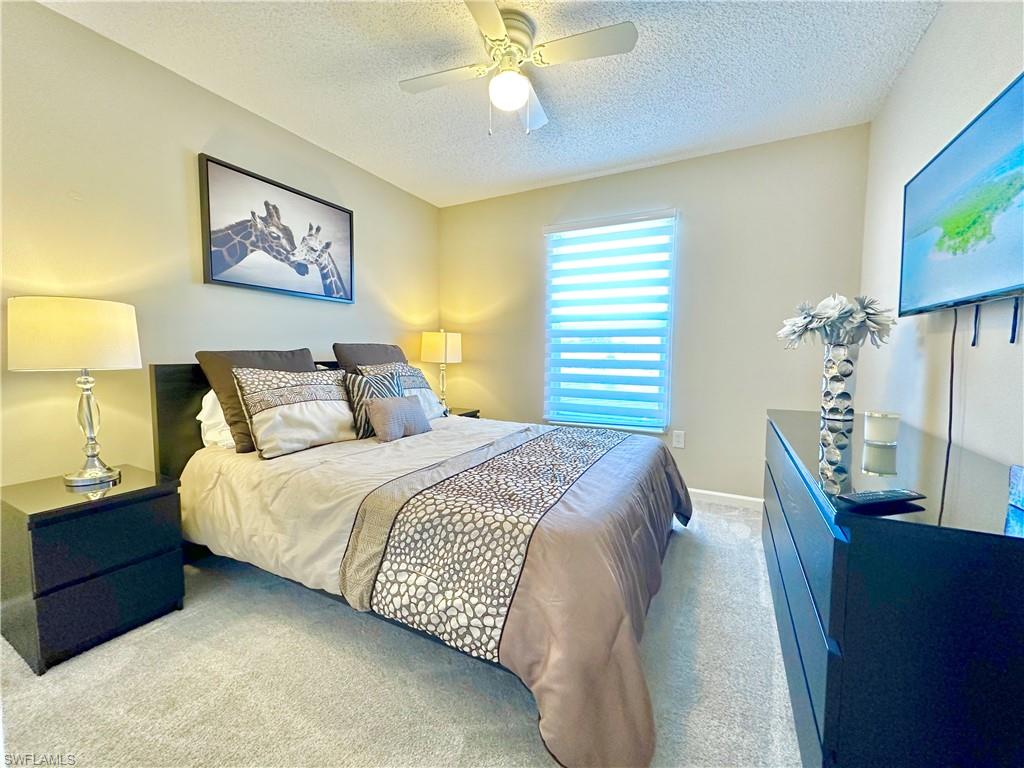 3639 Kent Drive Naples, FL 34112 - Photo 36 of 47 a bedroom with a bed and a chandelier