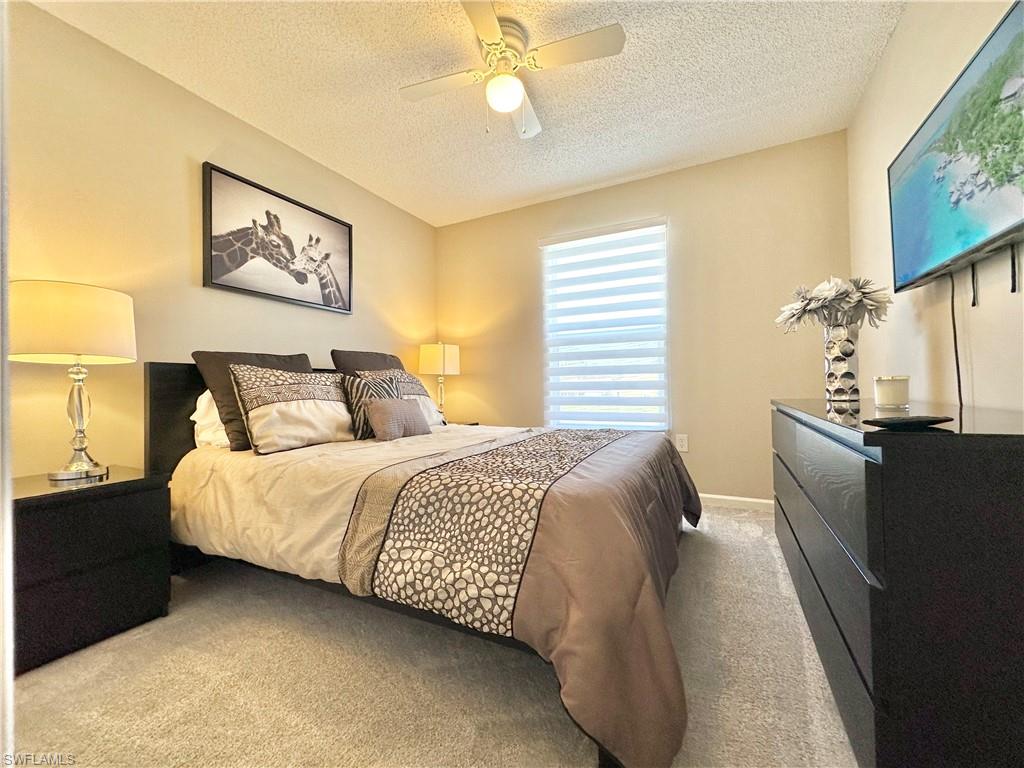 3639 Kent Drive Naples, FL 34112 - Photo 37 of 47 a bedroom with bed and wooden floor