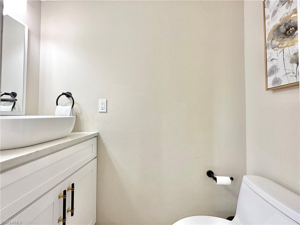 3639 Kent Drive Naples, FL 34112 - Photo 38 of 47 a bathroom with a sink a toilet and mirror