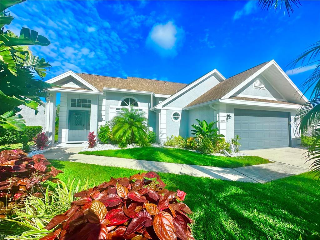 3639 Kent Drive Naples, FL 34112 - Photo 45 of 47 a front view of a house with a yard