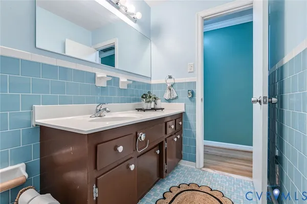 a bathroom with a sink a mirror and a shower
