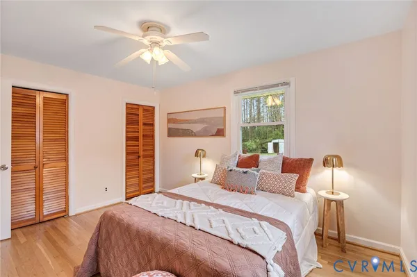 a bedroom with a bed and a large window with the outer view