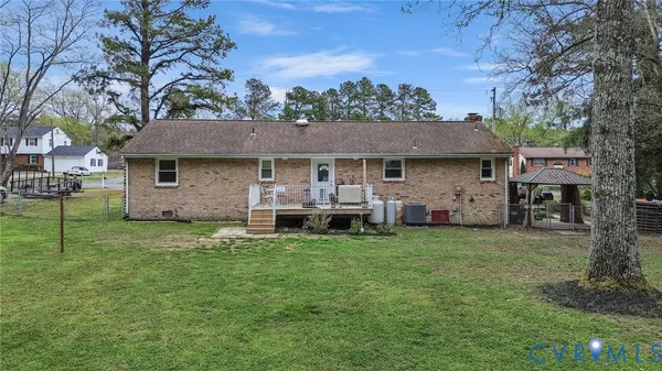 a view of a house with backyard and a tree