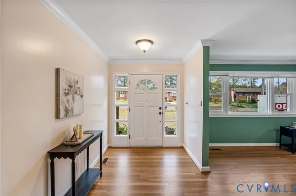 a view of a hallway with wooden floor and windows