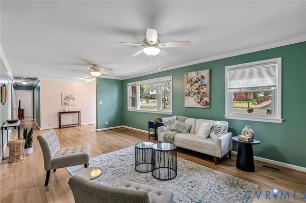 a living room with furniture and a chandelier
