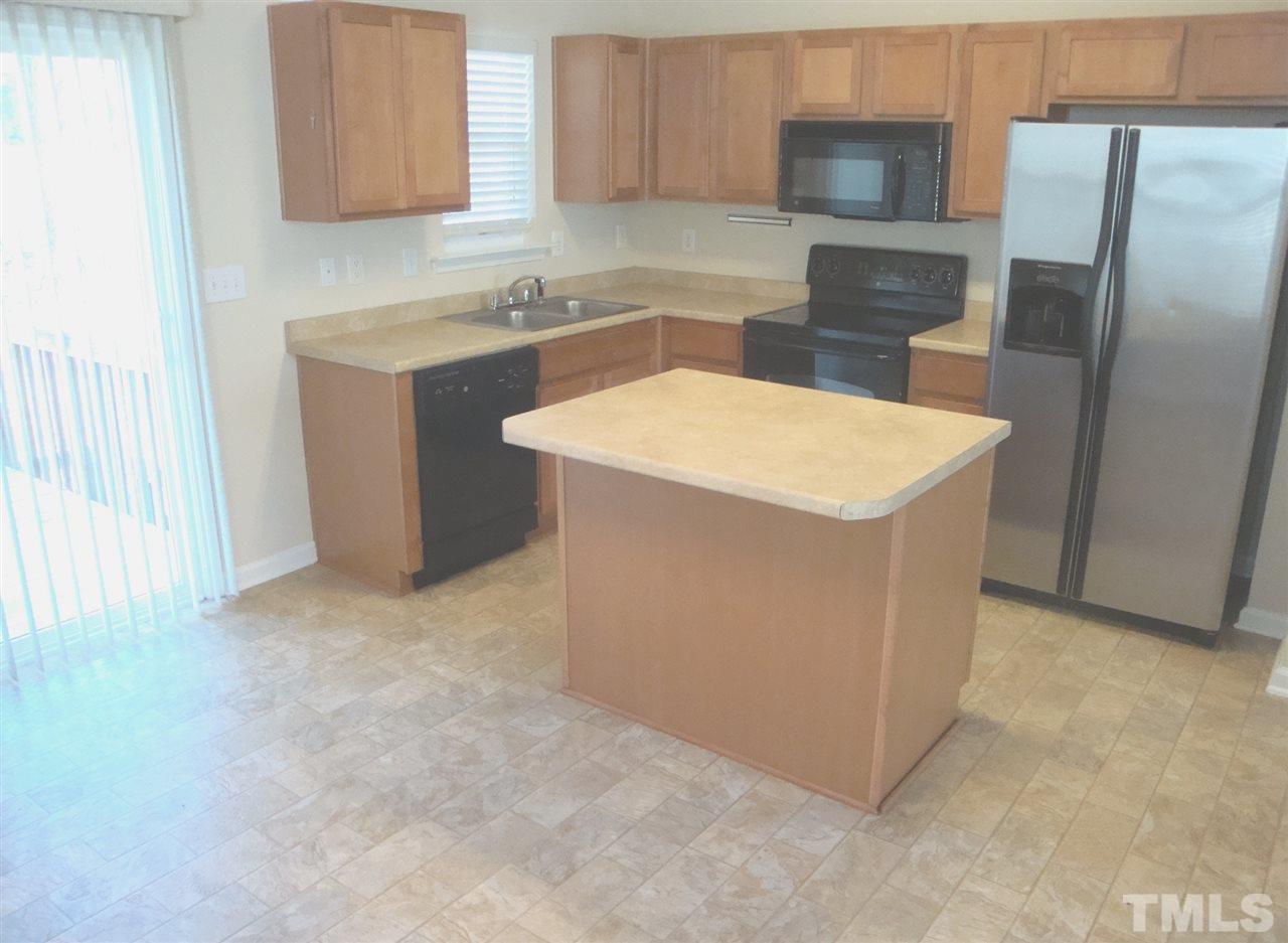 2204 Persimmon Ridge Drive Raleigh, NC 27604 - Photo 3 of 21 a kitchen with a sink a refrigerator and cabinets
