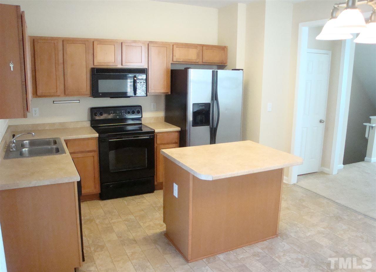 2204 Persimmon Ridge Drive Raleigh, NC 27604 - Photo 4 of 21 a kitchen with a stove a refrigerator and a sink