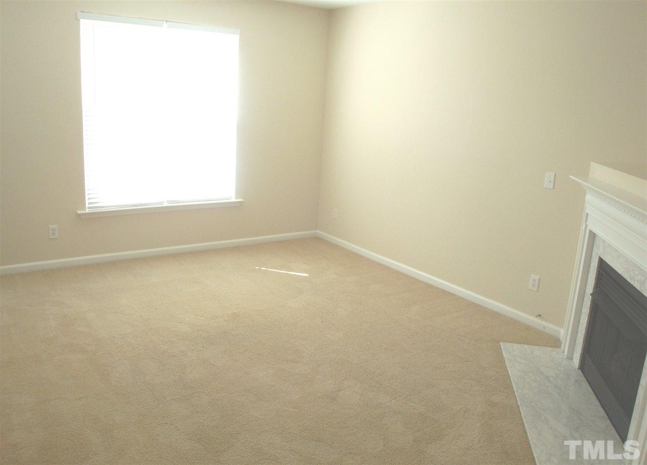2204 Persimmon Ridge Drive Raleigh, NC 27604 - Photo 5 of 21 an empty room with a fireplace