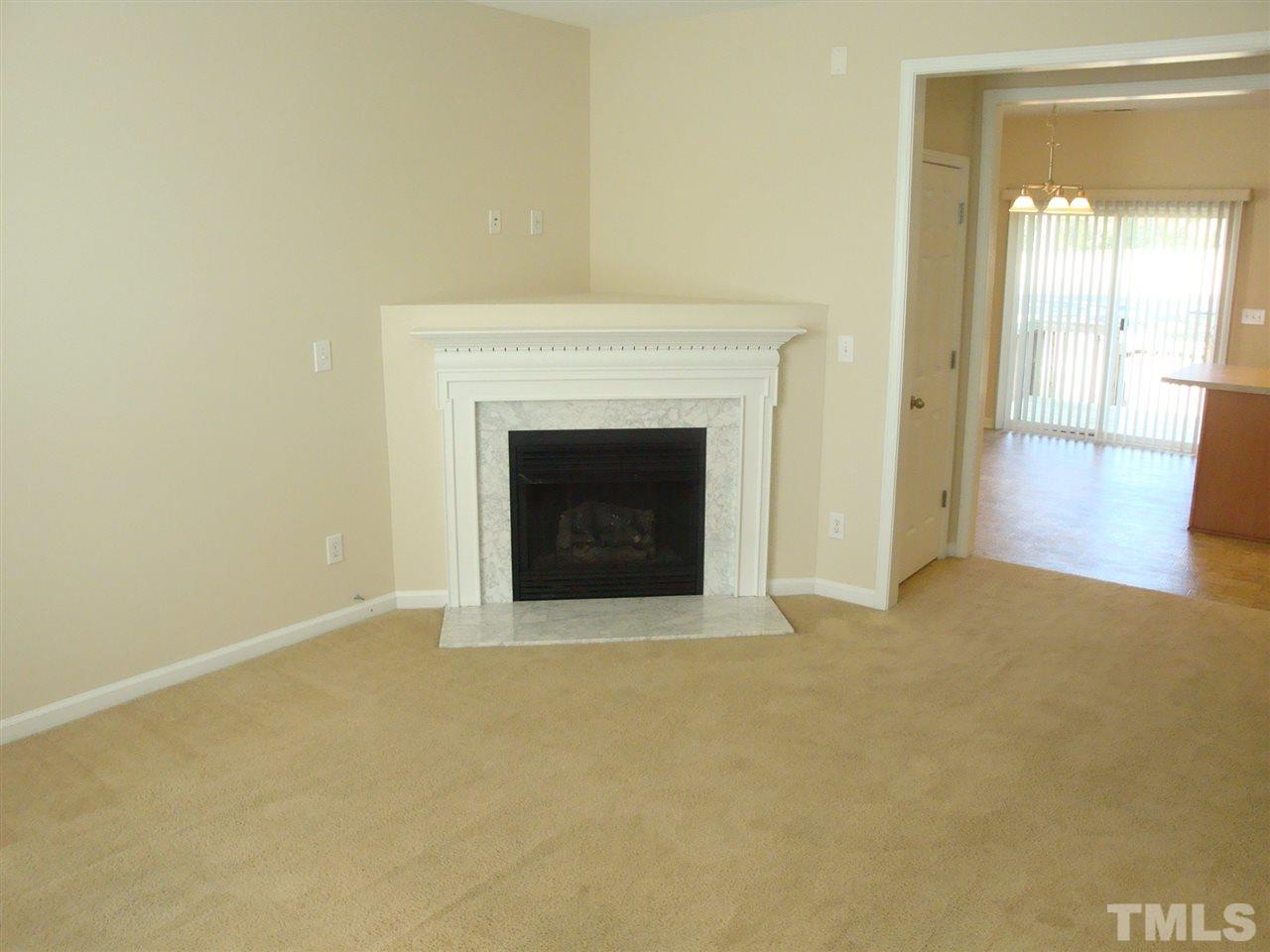 2204 Persimmon Ridge Drive Raleigh, NC 27604 - Photo 6 of 21 a view of an empty room with glass door and a fireplace