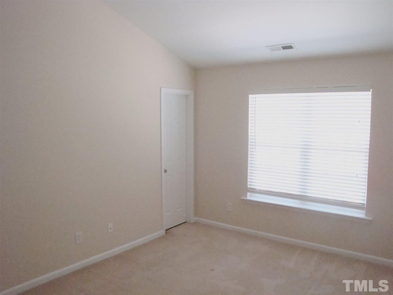 2204 Persimmon Ridge Drive Raleigh, NC 27604 - Photo 8 of 21 an empty room with a window