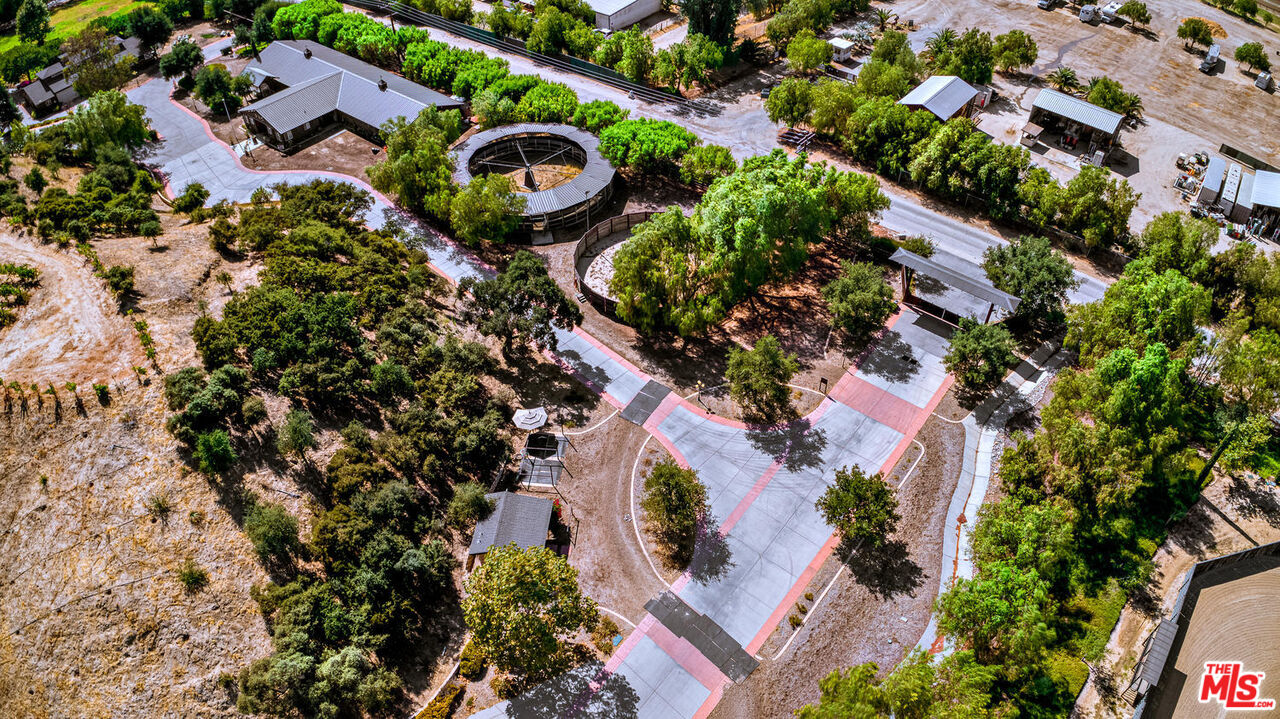 an aerial view of a house with a yard and garden