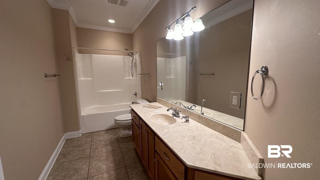 23289 McPhillips Road Loxley, AL 36551 - Photo 18 of 19 Bathroom featuring a single vanity with wood cabinetry, a light-toned countertop, and a large wall-mounted mirror