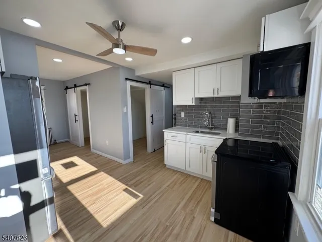 a kitchen with a sink stove and refrigerator