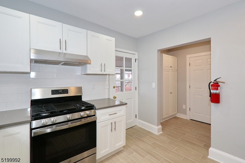 4 Gates Avenue, Unit A Summit, NJ 07901 - Photo 11 of 19 a kitchen with stainless steel appliances white cabinets and a stove top oven