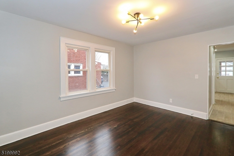 4 Gates Avenue, Unit A Summit, NJ 07901 - Photo 7 of 19 a view of an empty room with wooden floor and a window