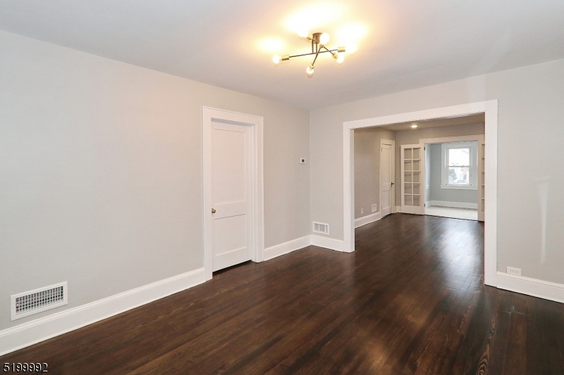 4 Gates Avenue, Unit A Summit, NJ 07901 - Photo 8 of 19 a view of a room with wooden floor and chandelier