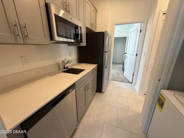 a kitchen with a sink and refrigerator