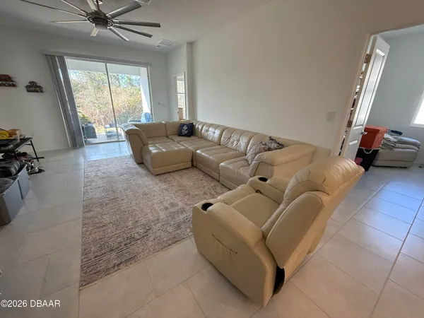a living room with furniture gym equipment and a large window