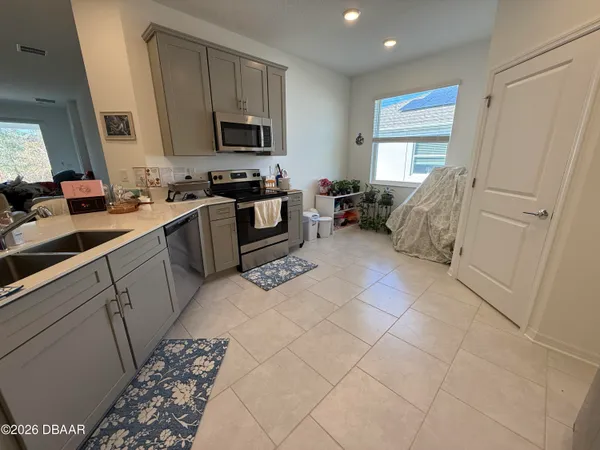 a kitchen with a sink cabinets and a window