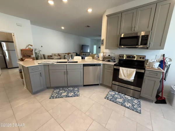 a kitchen with a sink a stove and microwave