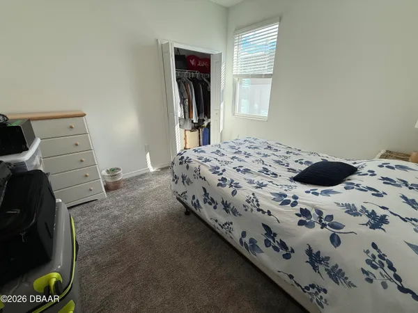 a bedroom with a bed and a closet